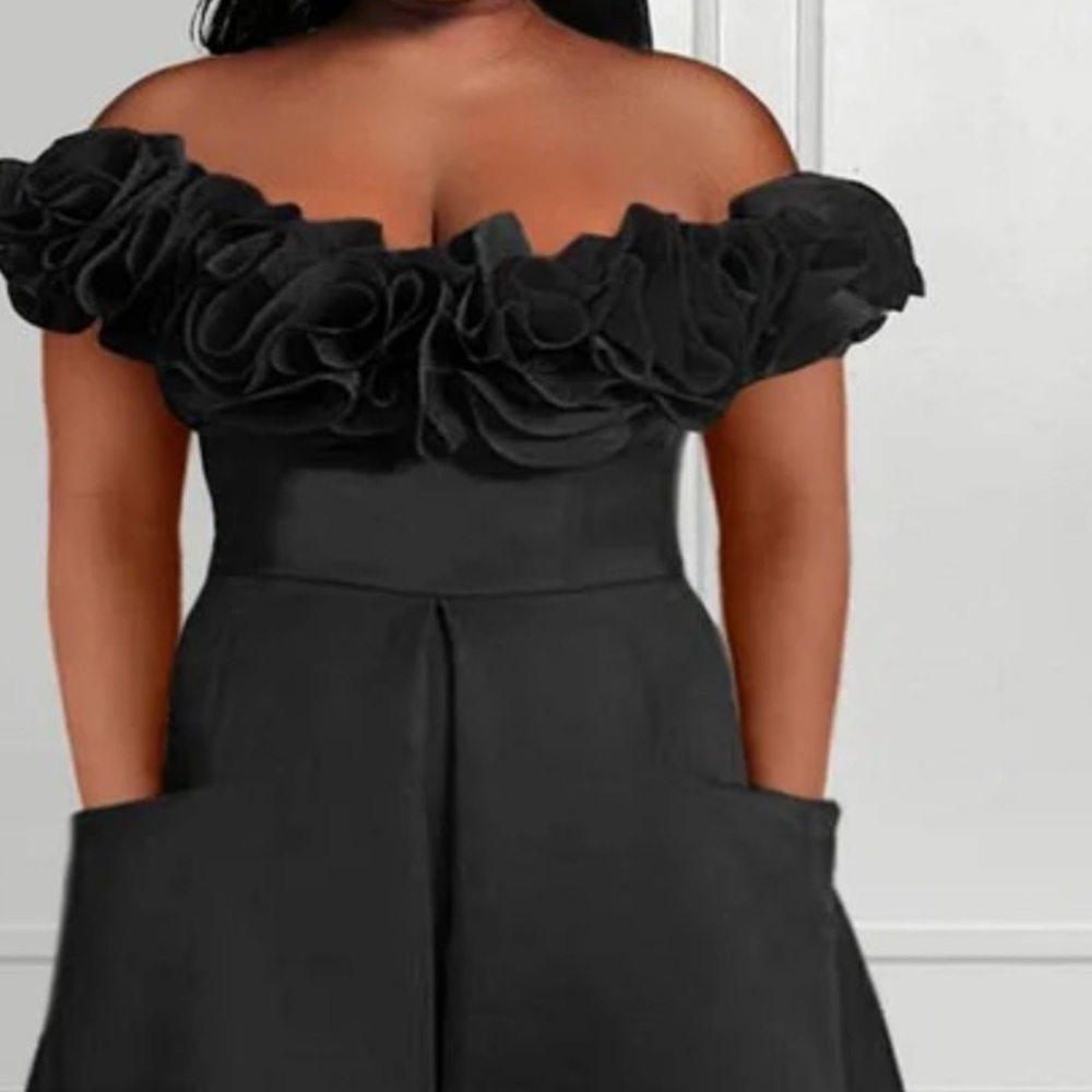 NEW never been worn jumpsuit with off the shoulder flowers.
